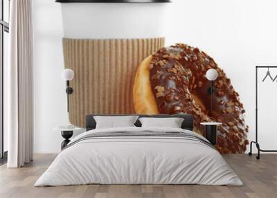 Cup of coffee with tasty donut on white background Wall mural