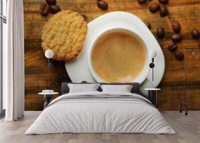 Cup of espresso and tasty cookie on wooden background Wall mural