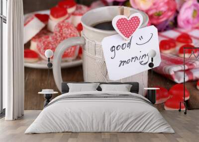 Cup of tea with card that says good morning on table close-up Wall mural