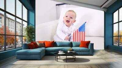 Cute baby boy on white couch with American flag, closeup Wall mural