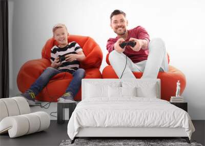 cute boy with father playing video game on white background Wall mural