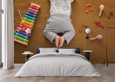 Cute boy with xylophone on color textile Wall mural