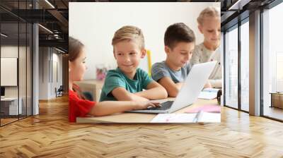 Cute children doing homework in classroom at school Wall mural