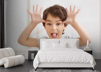 Cute emotional little boy on light blurred background Wall mural