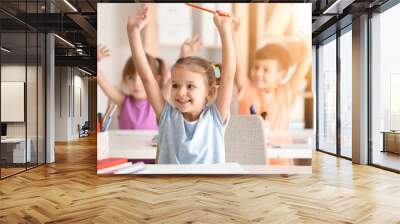 Cute girl at lesson in classroom Wall mural