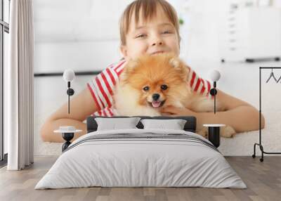 Cute girl with little dog on floor at home Wall mural