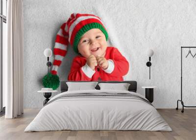 Cute little baby in Santa costume lying on soft fabric Wall mural