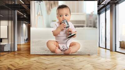 Cute little baby with microphone at home Wall mural