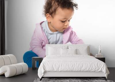 Cute little child with colorful book on white background Wall mural