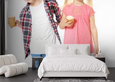 Cute little children eating ice cream on white background Wall mural