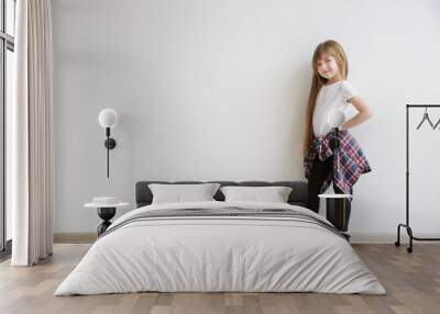 Cute little girl on light wall background. Fashion concept Wall mural