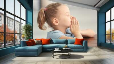 Cute little girl praying at home Wall mural