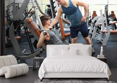 Dad and son training in modern gym Wall mural