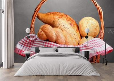 delicious bread in basket on wooden table on gray background Wall mural