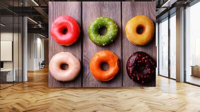 Delicious donuts with glaze on wooden background Wall mural