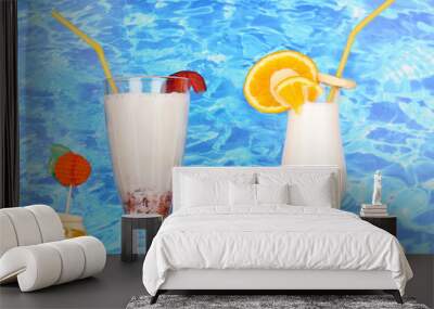 Delicious milk shake with fruit on table on blue sea background Wall mural