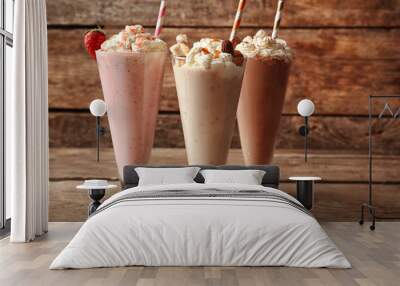 Delicious milkshakes on wooden background Wall mural