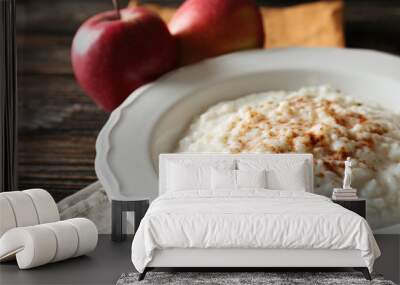 Delicious rice pudding with cinnamon on wooden background Wall mural