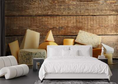 Different kinds of delicious cheese on table Wall mural