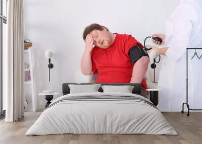 Doctor examining  patient obesity on light background Wall mural