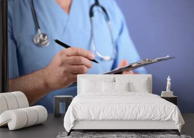 Doctor with clipboard on blue background Wall mural