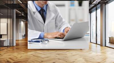 Doctor working on a computer in hospital Wall mural