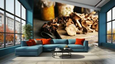 Dried mushrooms on cutting board, closeup Wall mural