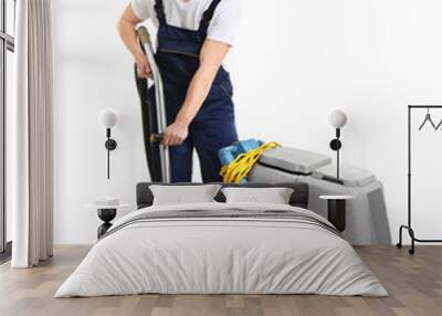 Dry cleaner's employee with special equipment on white background Wall mural