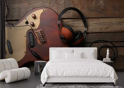 Electric guitar and headphones on wooden background Wall mural