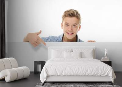 Emotional teenager with poster on white background Wall mural