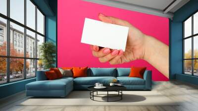 Female hand holding business card, on color background Wall mural