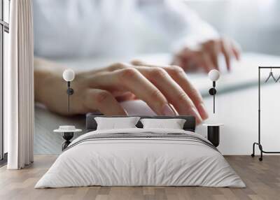 Female hand with computer mouse on table, closeup Wall mural