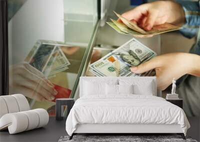 Female hand with money in cash department window. Currency Wall mural