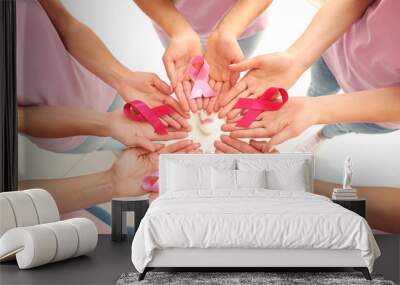 female hands holding pink ribbons. breast cancer concept Wall mural