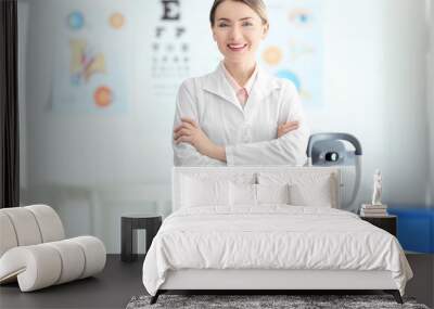 female ophthalmologist with crossed arms in clinic Wall mural