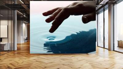 Finger touches water close up Wall mural