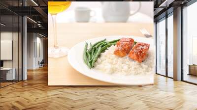 Fish fillet served with rice and green beans on kitchen table Wall mural