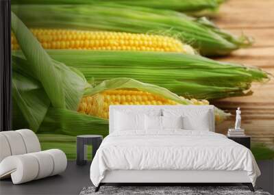 Fresh corn cobs on wooden table Wall mural