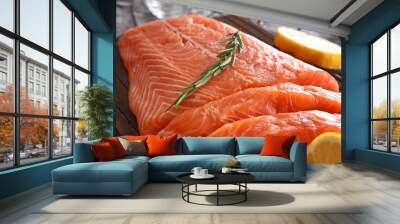 Fresh raw salmon fillet and rosemary on board, closeup Wall mural