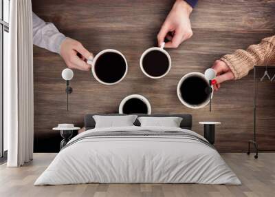 Friends drinking coffee on wooden table Wall mural