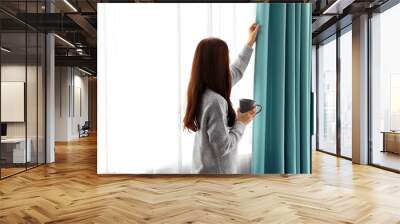 girl with hot drink near window Wall mural