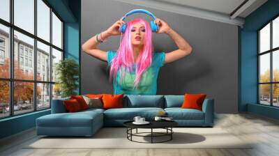 Glamour young woman with headphones on grey background Wall mural