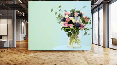 Glass vase with beautiful bouquet on light background Wall mural