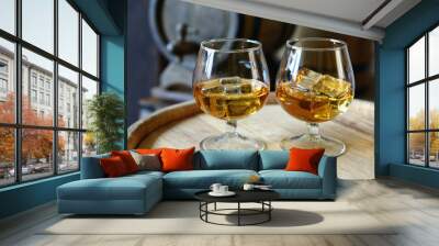 Glasses of brandy in cellar with old barrels Wall mural