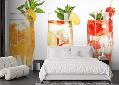 Glasses of fruit drinks with ice cubes isolated on white Wall mural