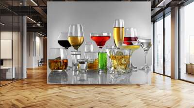 Glasses of wine and spirits on light background Wall mural