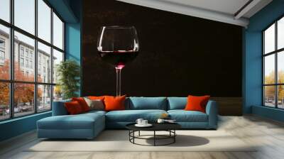 Goblet of red wine on wooden table on wooden wall background Wall mural