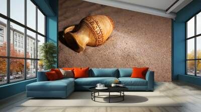 greek ceramic amphora on sand, close up Wall mural