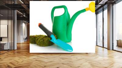 Green watering can with gardener accessories isolated on white Wall mural