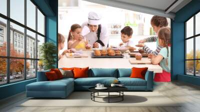 group of children and teacher in kitchen during cooking classes Wall mural